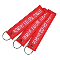 Brelok zawieszka REMOVE BEFORE FLIGHT Czerwona